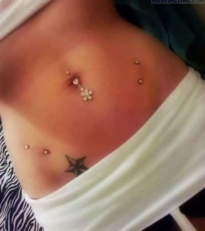 hip piercing and star tattoo