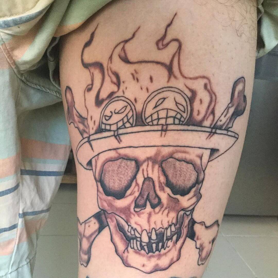 one piece skull tattoo on thigh