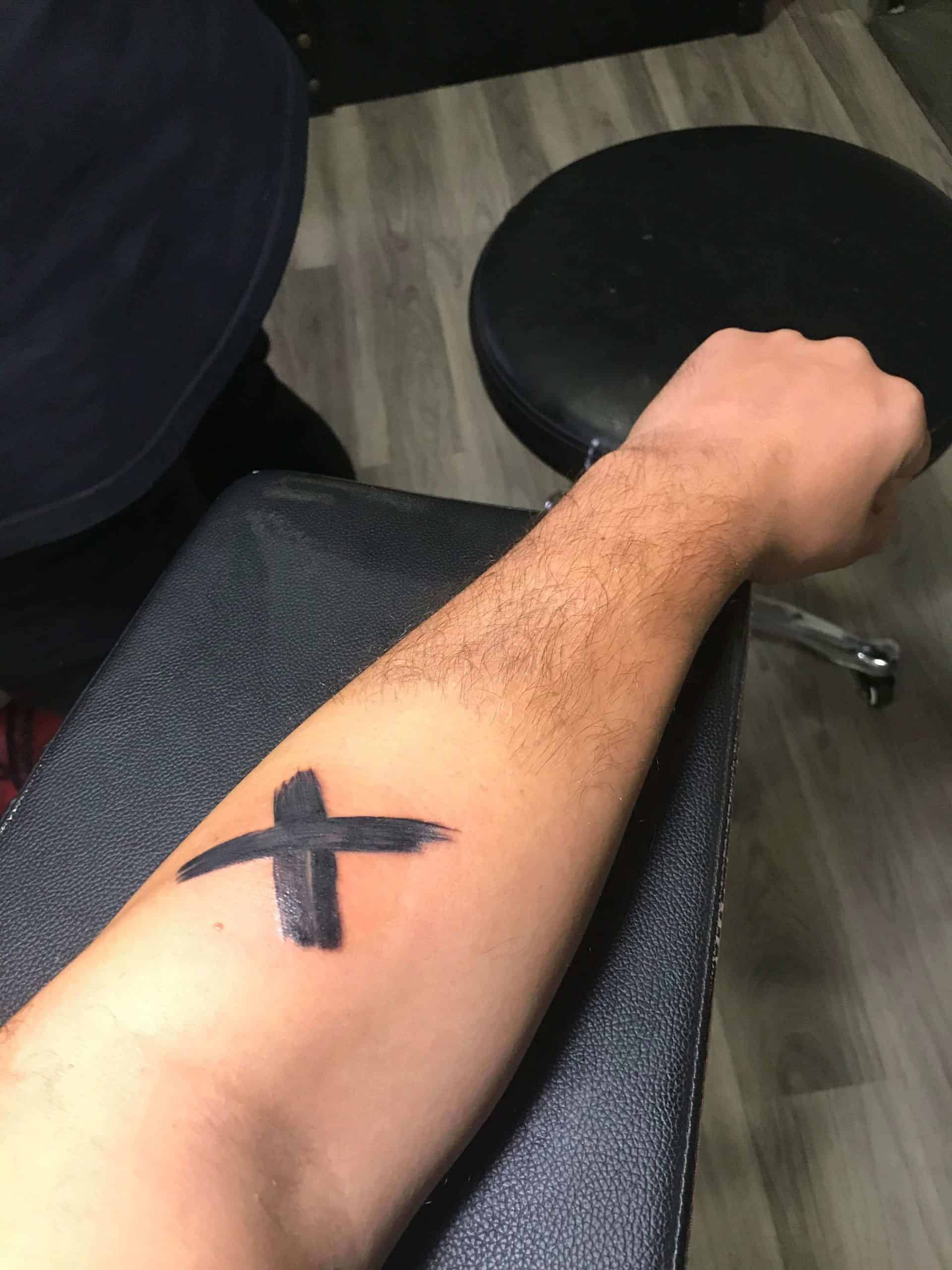 one piece x tattoo on arm