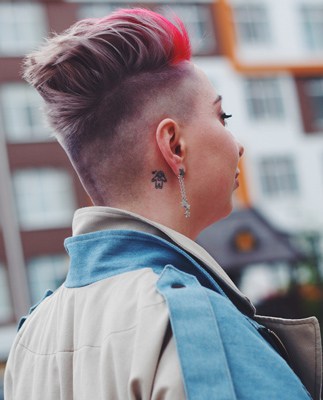 woman with tattoo behind ear