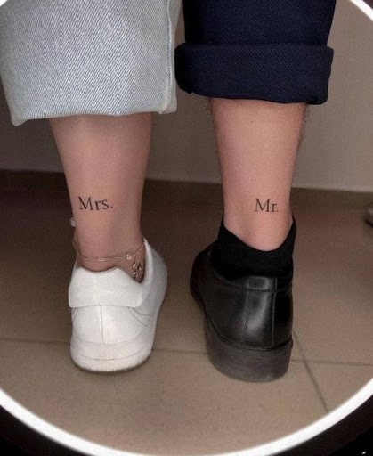 A couple with tattoos on back of legs_