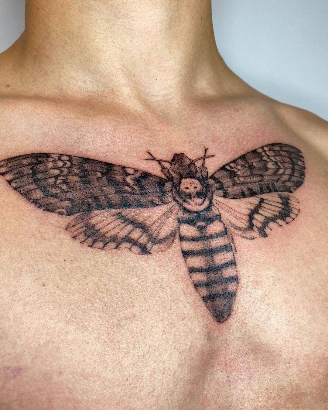 death moth tattoo on chest