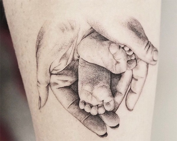 Mother holding babies feet tattoo