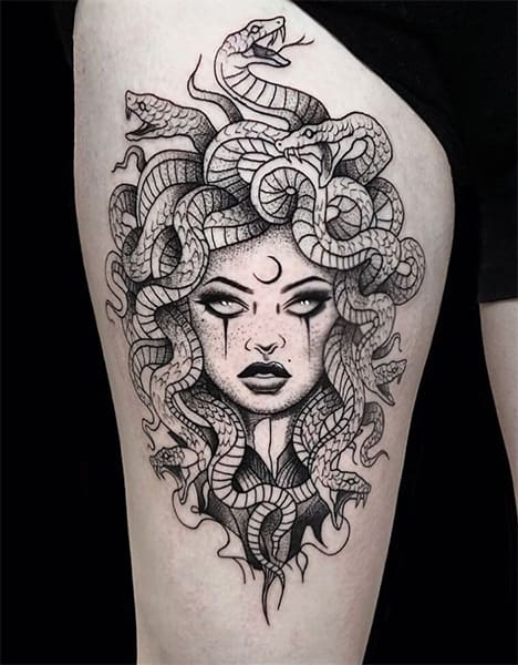 black ink medusa tattoo on arm