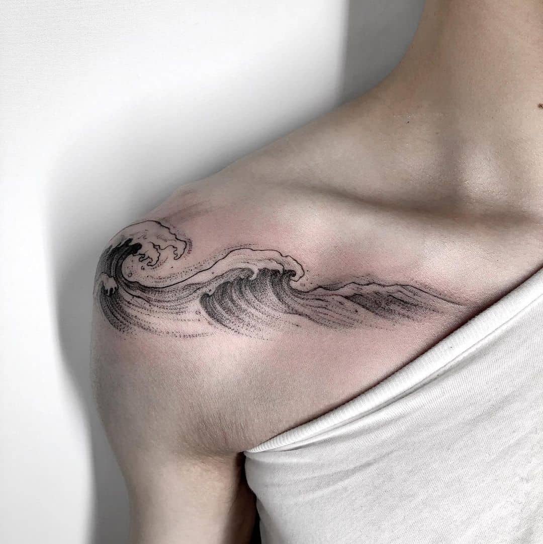 black and white waves on shoulder tattoo